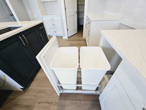 Bathroom featuring tasteful backsplash and hardwood / wood-style floors