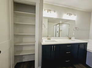 Bathroom with vanity, wood-type flooring, and walk in shower