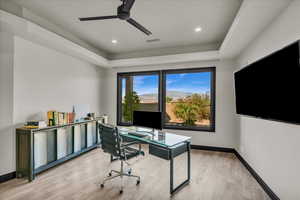 Home office featuring light wood-type flooring and ceiling fan