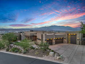 View of front of house featuring a mountain view and a garage