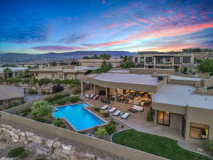 Pool at dusk featuring a patio and a mountain view