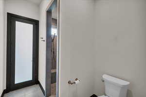 Bathroom featuring tile patterned flooring and toilet