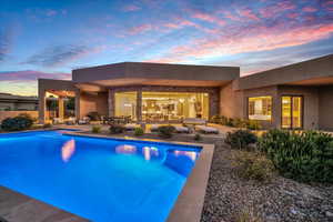 Pool at dusk with a patio area