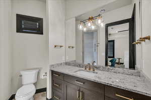 Bathroom featuring vanity, toilet, and tile patterned flooring