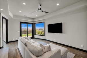 Living room featuring a textured ceiling, ceiling fan, and hardwood / wood-style flooring