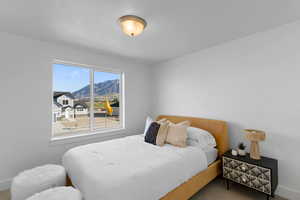 Carpeted bedroom with a mountain view