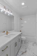 Full bathroom with bathtub / shower combination, toilet, and vanity