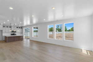 Unfurnished living room with light hardwood / wood-style floors