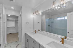 Bathroom featuring vanity and a shower with shower door