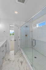 Bathroom featuring vanity and walk in shower