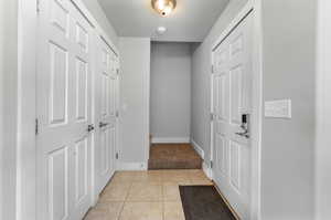 Entrance foyer featuring light tile patterned floors