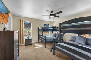 Bedroom featuring ceiling fan and light colored carpet