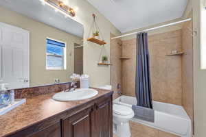 Full bathroom featuring vanity, toilet, shower / tub combo, and tile patterned floors