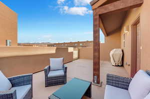 View of patio / terrace with a balcony and a grill