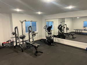 Workout area featuring a textured ceiling