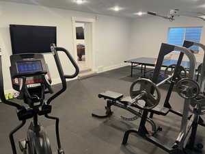 Exercise area featuring a textured ceiling