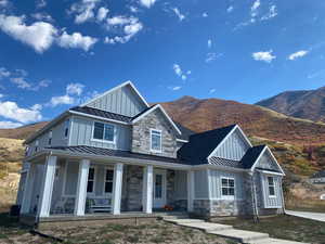 View of front of property with a porch and a mountain view