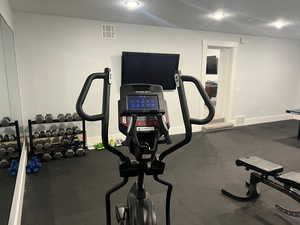 Workout area featuring a textured ceiling