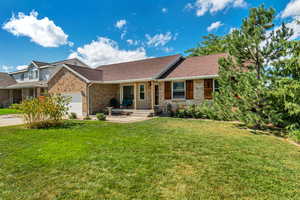 Ranch-style home with a garage and a front lawn