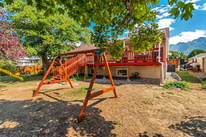 View of play area with a deck with mountain view and central AC