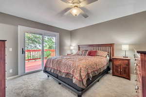 Bedroom featuring light colored carpet, access to outside, and ceiling fan