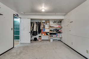 Bedroom featuring a closet and a textured ceiling