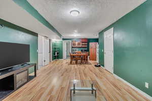 Unfurnished living room with a textured ceiling and wood-type flooring