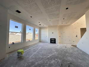 Unfurnished living room featuring a wood stove