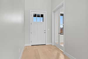 Entrance foyer featuring light wood-style floors and baseboards
