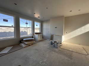 Unfurnished living room with plenty of natural light