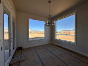 Unfurnished dining area featuring a mountain view and an inviting chandelier