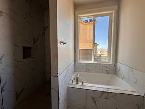 Bathroom featuring tiled bath