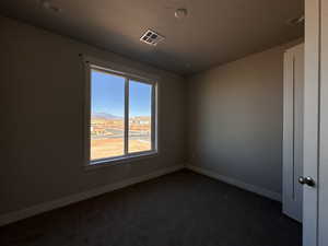 Carpeted empty room with a mountain view