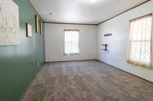 Carpeted empty room with ornamental molding