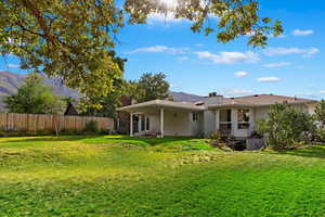 Back of house with a lawn