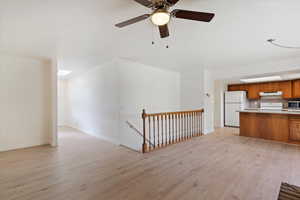 Unfurnished living room featuring light hardwood / wood-style floors and ceiling fan