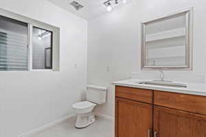 Bathroom featuring vanity and toilet