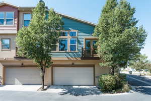 Multi unit property featuring a garage and a balcony