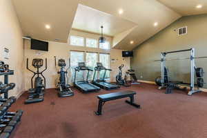 Gym featuring high vaulted ceiling