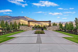 View of community with a mountain view and a lawn