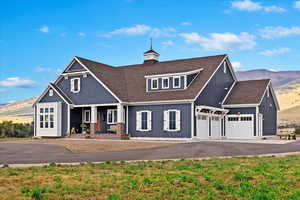 View of front facade with a mountain view and a garage