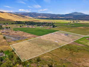 Birds eye view of property with a mountain view and a rural view