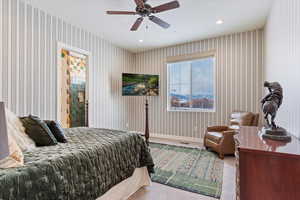 Bedroom featuring ceiling fan, carpet, and a textured ceiling