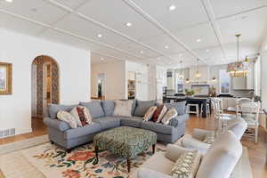 Living room featuring a chandelier and light wood-type flooring