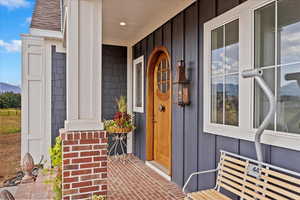 Doorway to property with covered porch