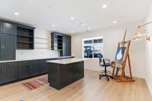 Kitchen featuring a center island, hanging light fixtures, and light hardwood / wood-style flooring