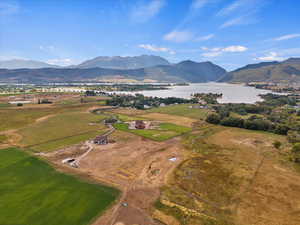 Drone / aerial view featuring a water and mountain view