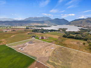 Drone / aerial view featuring a water and mountain view