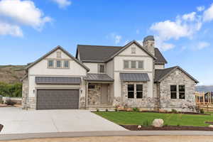 View of front of house featuring a front lawn and a 4 garage