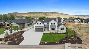 View of front of home with a front lawn and a mountain view